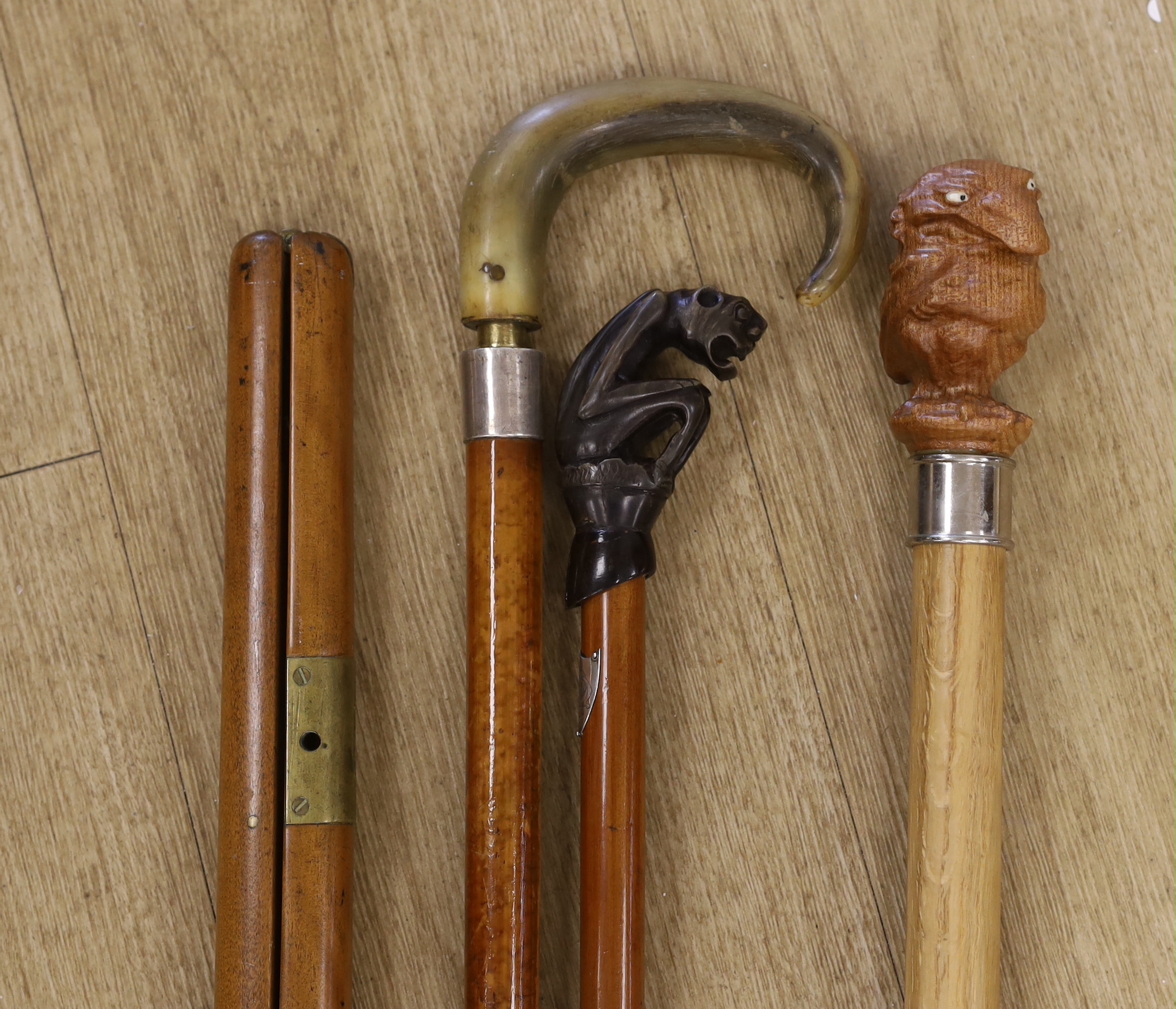 Four canes / walking sticks including a horse measuring stick and a military pace stick